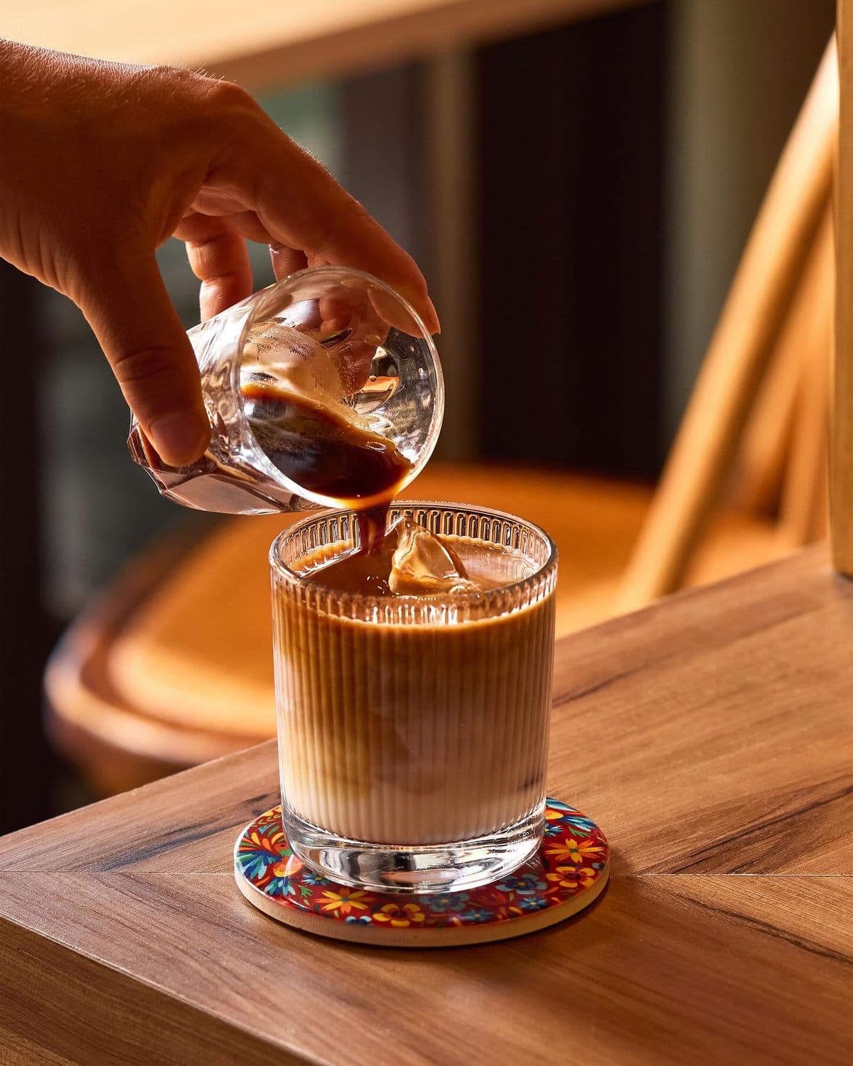 Espresso poured over ice to finish a freshly made iced latte